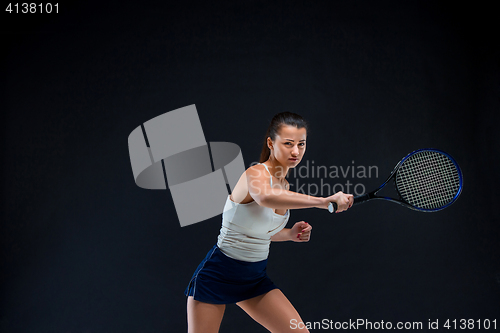 Image of Portrait of beautiful girl tennis player with a racket on dark background