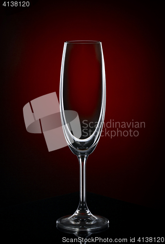 Image of Empty wine glass on dark red