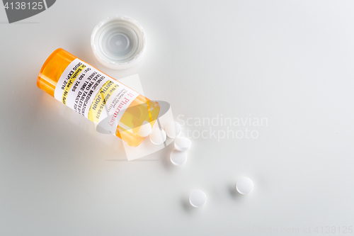 Image of Non-Proprietary Medicine Prescription Bottle and Spilled Pills  