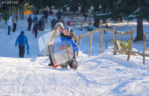 Image of teenagers slide downhill 