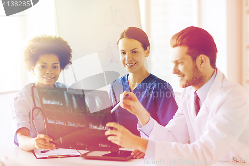 Image of group of happy doctors discussing x-ray image