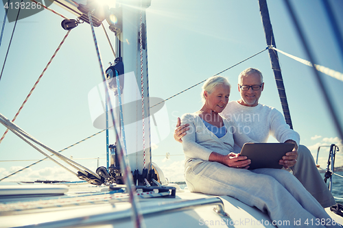 Image of senior couple with tablet pc on sail boat or yacht