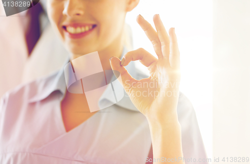 Image of close up of doctor or nurse showing ok sign