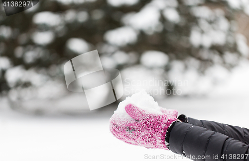 Image of close up of woman holding snow outdoors