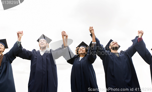 Image of happy students or bachelors celebrating graduation