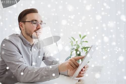 Image of happy creative male office worker with tablet pc