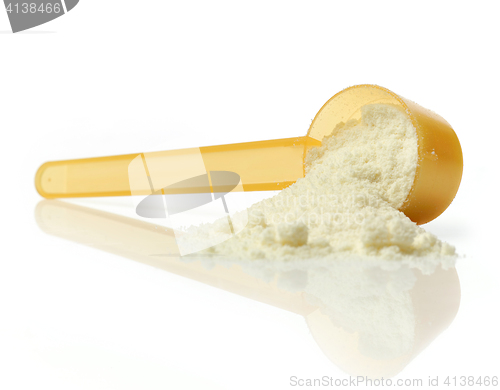 Image of powdered milk in plastic spoon