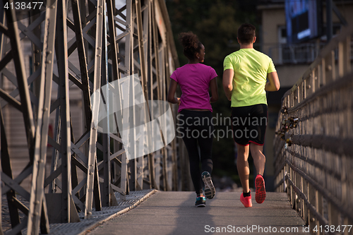 Image of multiethnic couple jogging in the city