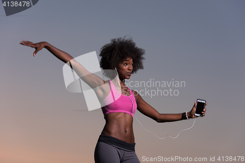 Image of young black girl dances outdoors