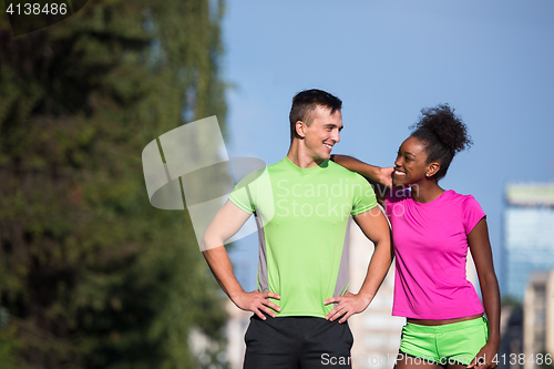 Image of portrait of young multietnic jogging couple ready to run