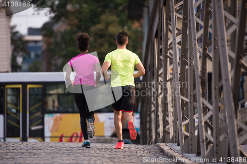 Image of multiethnic couple jogging in the city