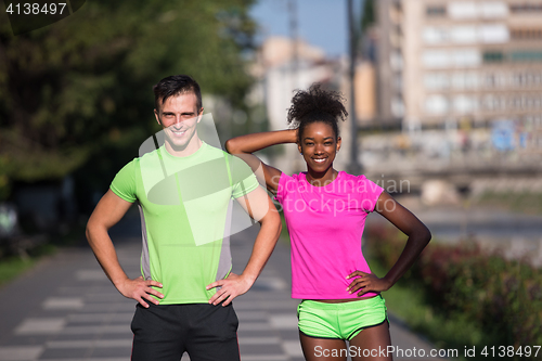 Image of portrait of young multietnic jogging couple ready to run