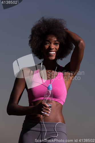 Image of african american woman jogging in nature