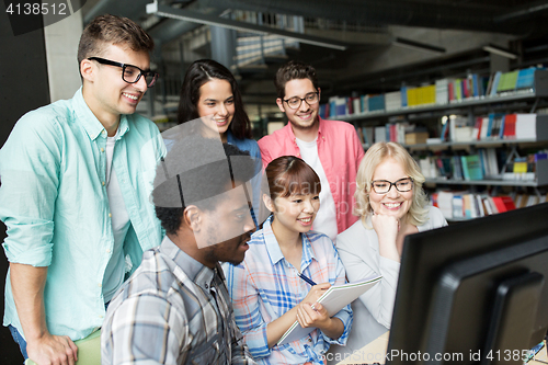 Image of international students with computers at library