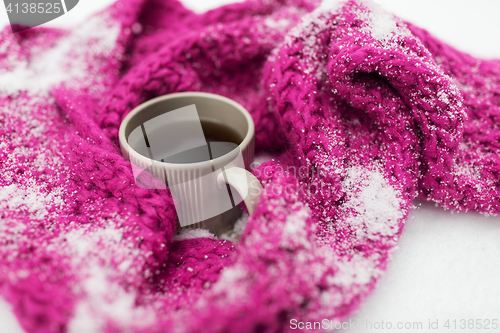 Image of close up of tea or coffee and winter scarf in snow