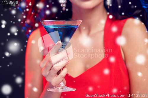 Image of close up of beautiful woman with cocktail at night