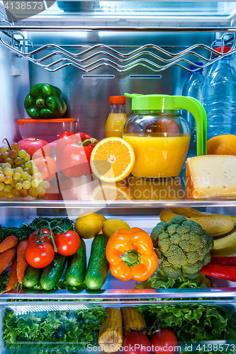 Image of Open refrigerator filled with food