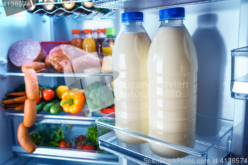 Image of Open refrigerator filled with food