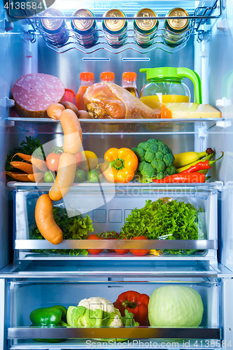 Image of Open refrigerator filled with food