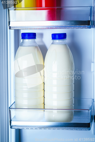 Image of Bottles of milk in the fridge