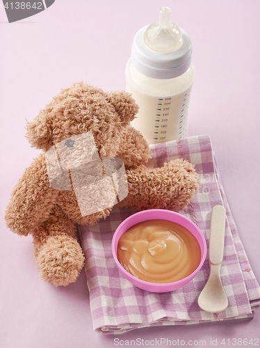 Image of bowl of pureed apple and baby milk bottle