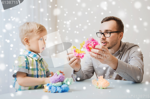 Image of father and son playing with ball clay at home