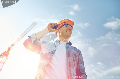 Image of close up of builder in hardhat with walkie talkie