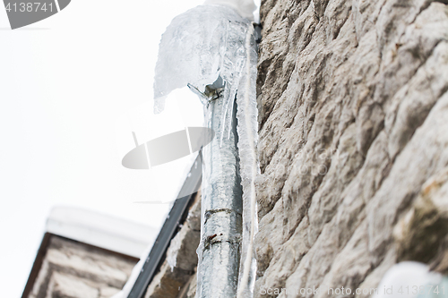 Image of icicles hanging from building drainpipe