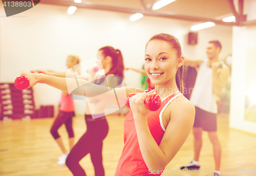 Image of group of people working out with dumbbells