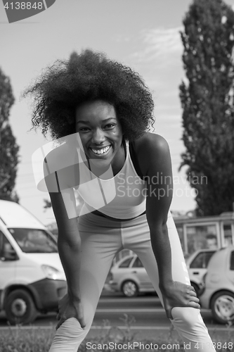 Image of Portrait of sporty young african american woman running outdoors