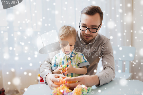Image of father and son playing with ball clay at home