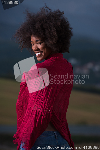 Image of outdoor portrait of a black woman with a scarf