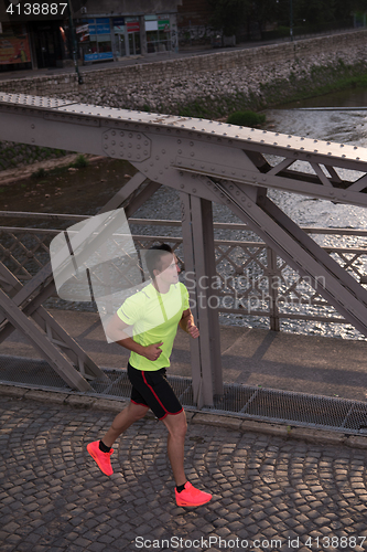 Image of a young man jogging in the city