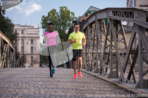 Image of multiethnic couple jogging in the city