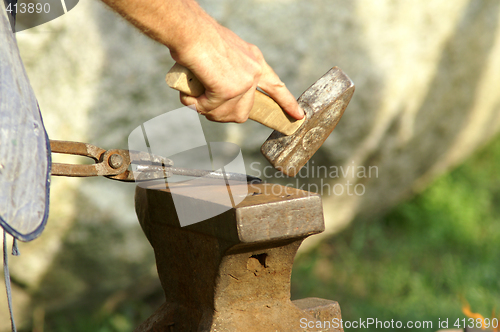 Image of black smith make with forge hammer an arrow