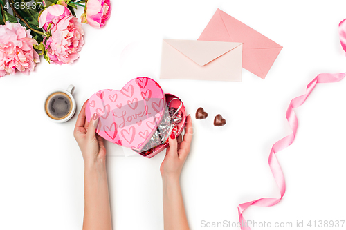 Image of The female hands with gift box on white background