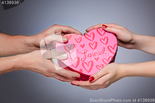 Image of Hands giving and receiving a present