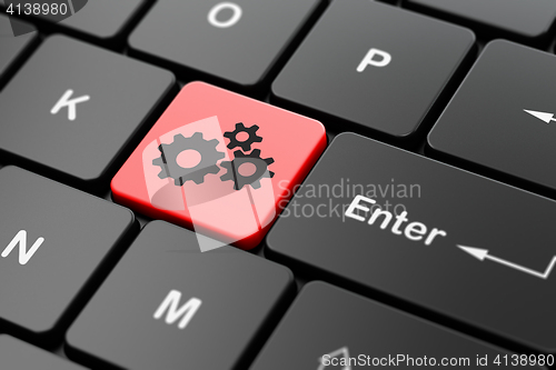 Image of Finance concept: Gears on computer keyboard background