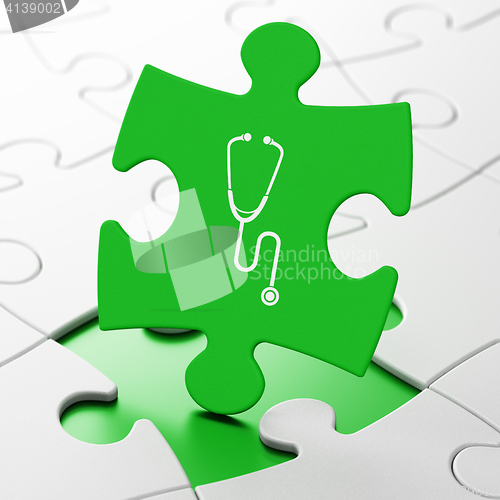 Image of Medicine concept: Stethoscope on puzzle background