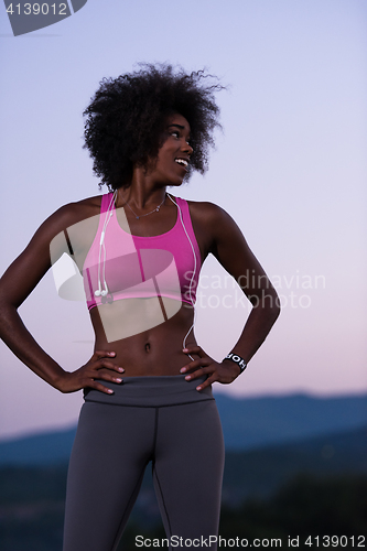 Image of portrait of african american woman jogging in nature