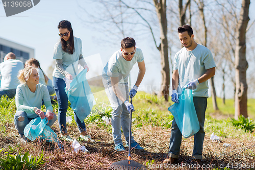 Image of volunteers with garbage bags cleaning park area