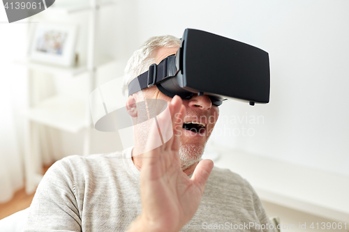Image of old man in virtual reality headset or 3d glasses