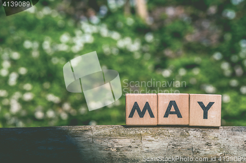 Image of May month label in a green garden