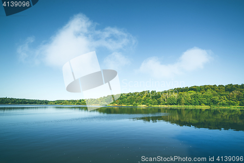 Image of Lake with reflection of green trees