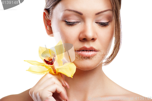 Image of young beautiful woman with orchid