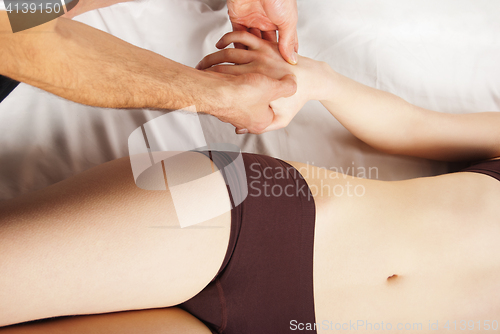 Image of pretty woman getting hand massage