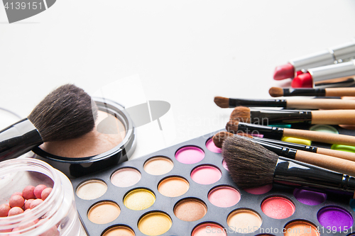 Image of Make-up multicolored palette, brushes and cosmetics.