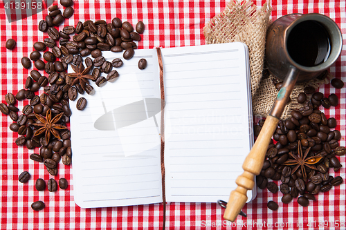 Image of Blank paper, coffe bean and coffee cup on wood