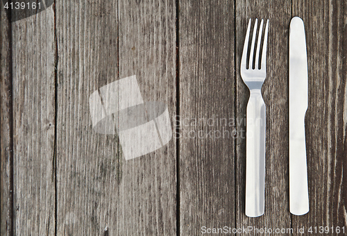 Image of Knife and fork  on old wooden table