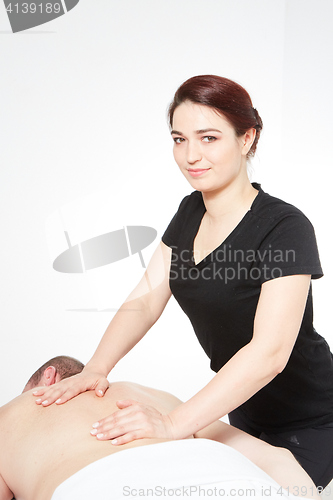 Image of Young woman getting back massage